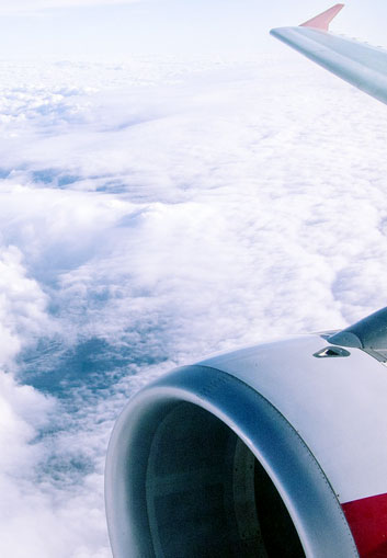 Testing Services for FAA An airplane wing over blue cloudy sky